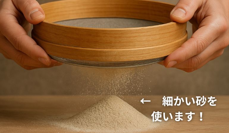 ふるいにかけて細かい砂を選別している様子。絵具作りに使用するため、より粒子の細かい砂を集めている場面。